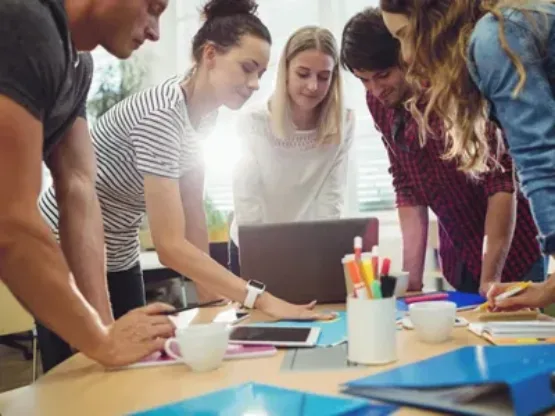 Teachers around laptop